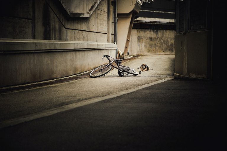 A conceptual illustration of a bicycle resting on a paved path near urban infrastructure, emphasizing a somber and investigative atmosphere.