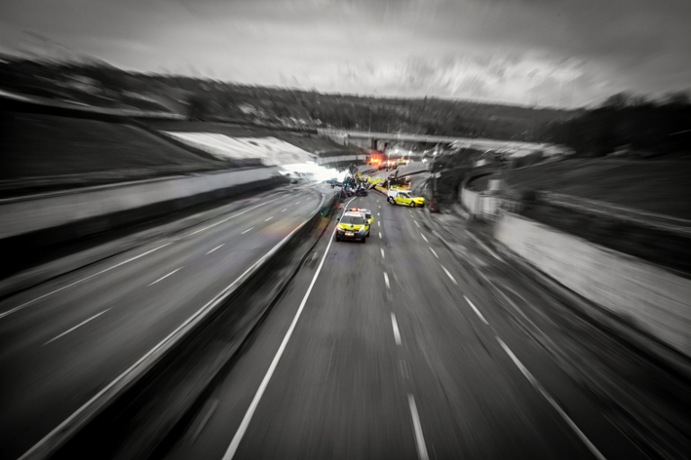 Conceptual illustration of a vehicular incident on a dual carriageway at night, focusing on the aftermath and investigation.