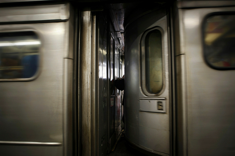 Conceptual illustration of a subway train door during rush hour, emphasizing the dangerous proximity of a person to the closing mechanism.