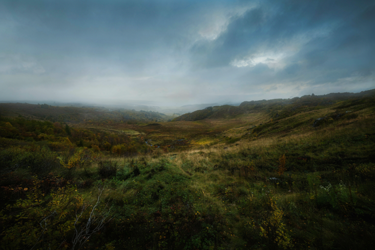 Editorial illustration depicting the arrival of a cool, autumnal atmosphere over a landscape.