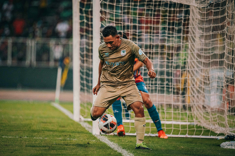 Guyana player scores a goal in a football match