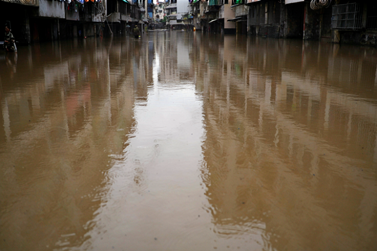 Editorial illustration of a flooded urban street in a city under heavy rain.